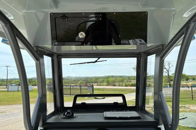 Slide: The Image of Interior view of 2026 Sea Pro 245FLX Sandbar boat, showcasing helm and windshield. - 15