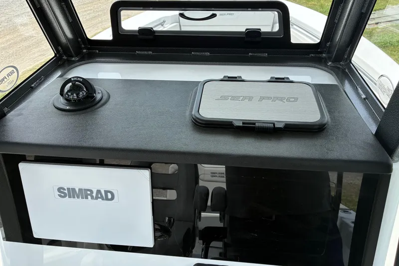 Slide: The Image of Dashboard of 2026 Sea Pro 245FLX Sandbar boat with Simrad and Ritchie compass. - 16