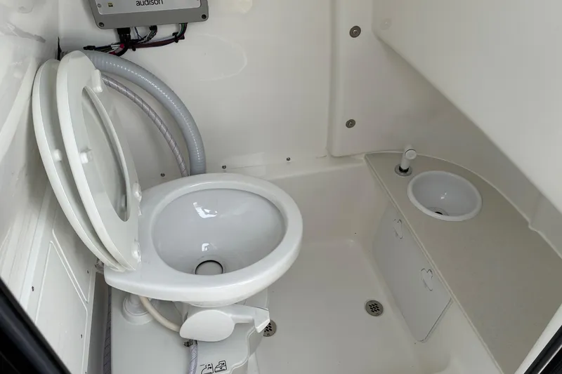 Slide: The Image of Interior of 2026 Sea Pro 245FLX Sandbar boat bathroom with toilet and sink. - 18