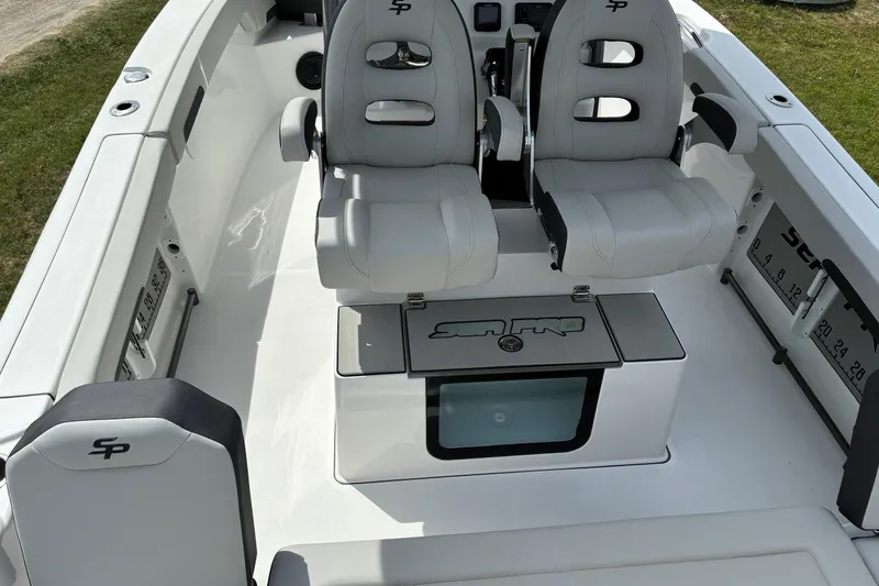 Slide: The Image of 2026 Sea Pro 245FLX Sandbar boat interior with dual seats and storage compartments. - 20
