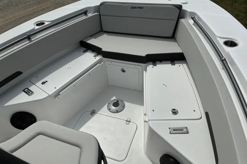 Slide: The Image of Interior view of 2026 Sea Pro 245FLX Sandbar boat, featuring seating and storage compartments. - 6