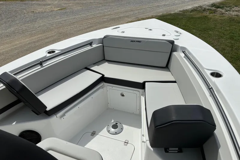 Slide: The Image of 2026 Sea Pro 245FLX Sandbar boat interior with cushioned seating and storage compartments. - 7