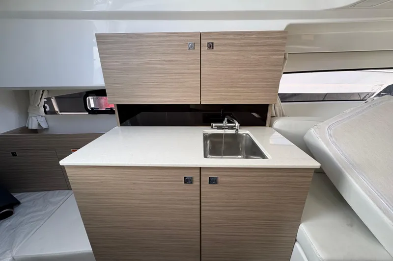 Slide: The Image of 2026 Jeanneau Leader 9.0 WA Series 2 interior with modern kitchenette and sink. - 12