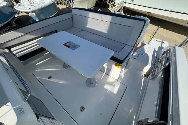 Slide: The Image of 2026 Jeanneau Leader 9.0 WA Series 2 boat interior with seating and table. - 4