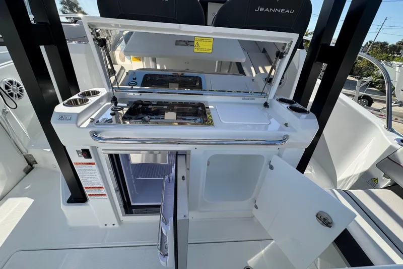 Slide: The Image of 2026 Jeanneau Leader 9.0 WA Series 2 boat kitchen with open fridge and stove. - 5