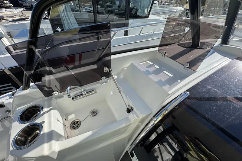 Slide: The Image of 2026 Jeanneau Leader 9.0 WA Series 2 boat cockpit with sink and cup holders. - 7