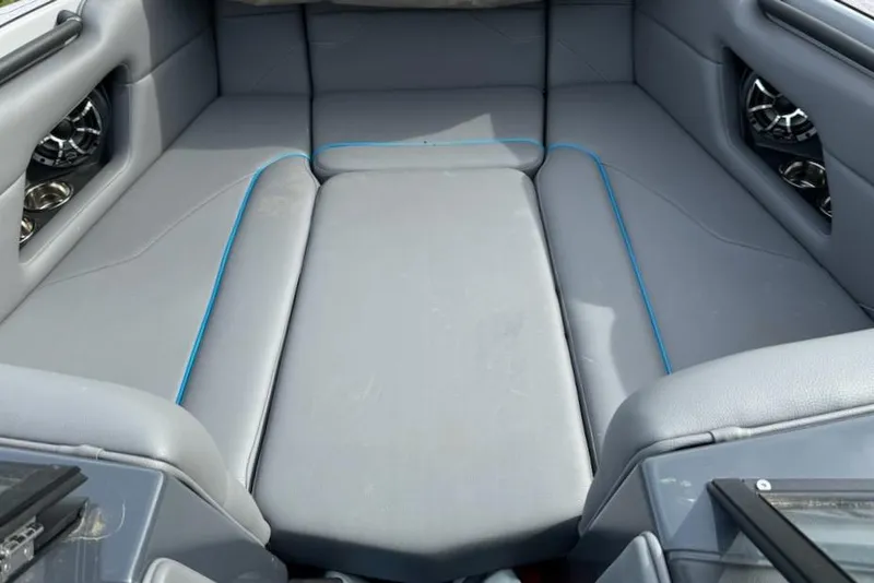 Slide: The Image of 2023 Moomba Mojo boat interior with gray seating and blue accents. - 3