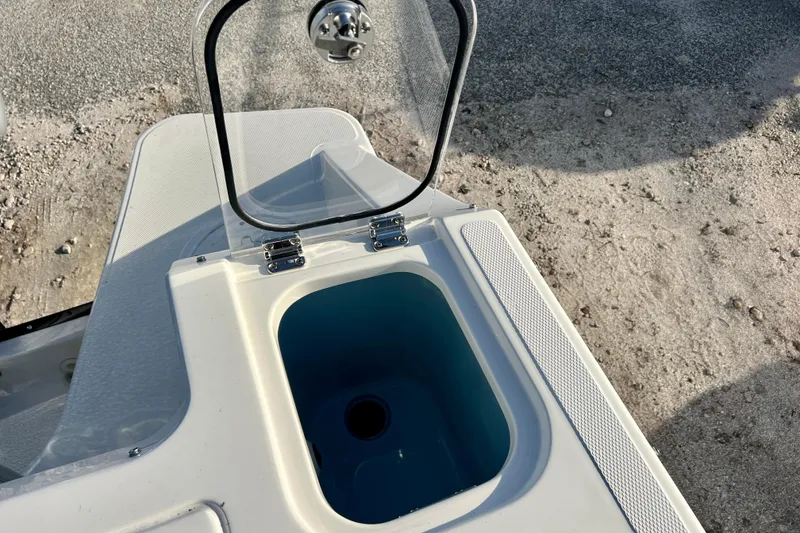 Slide: The Image of Boston Whaler 240 Vantage 2025, open storage compartment on boat. - 12