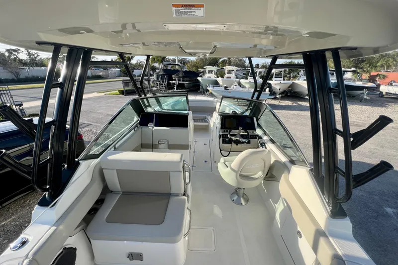 Slide: The Image of Interior of 2025 Boston Whaler 240 Vantage with helm and seating area. - 13