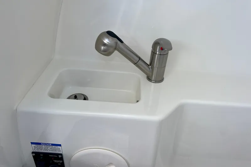 Slide: The Image of Boston Whaler 240 Vantage 2025, stainless steel faucet and sink. - 21