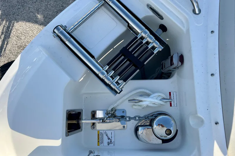 Slide: The Image of Anchor compartment of 2025 Boston Whaler 240 Vantage with stainless steel ladder. - 26