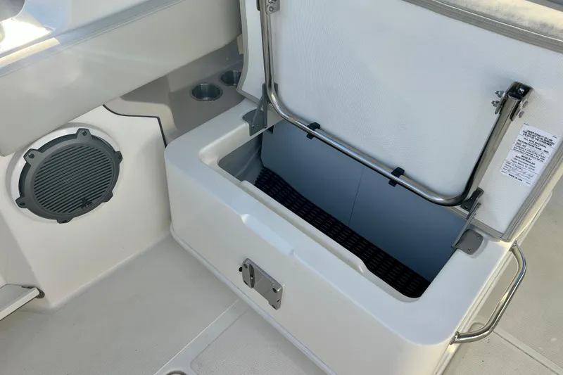 Slide: The Image of Boston Whaler 240 Vantage 2025, open storage compartment and speaker. - 29