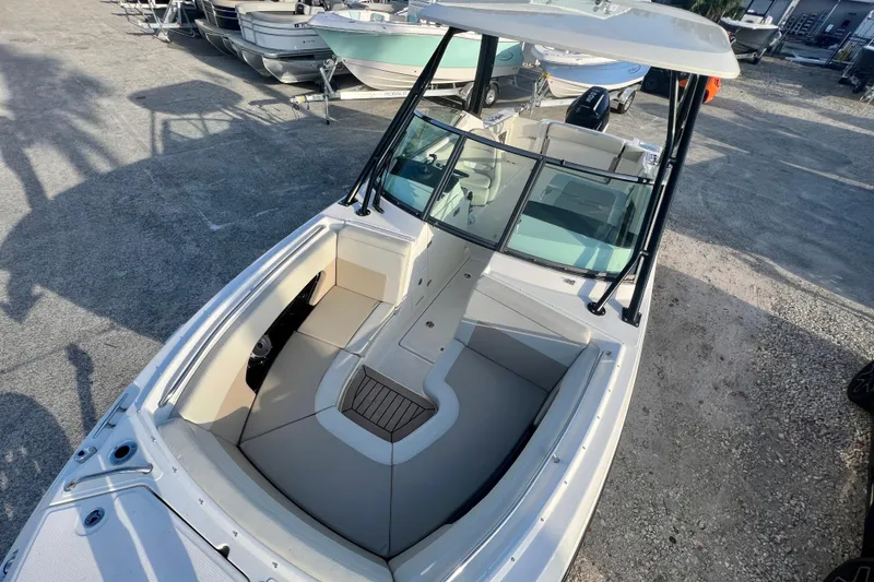 Slide: The Image of 2025 Boston Whaler 240 Vantage boat in a parking area. - 33