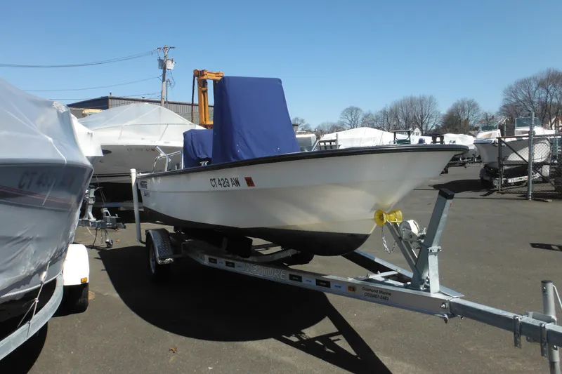 Slide: The Image of 1999 Maritime Skiff 1690 boat on trailer in a marina storage area. - 10