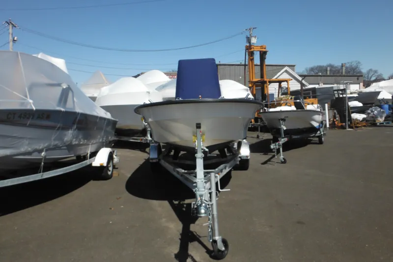 Slide: The Image of 1999 Maritime Skiff 1690 boat on trailer in outdoor storage lot. - 11