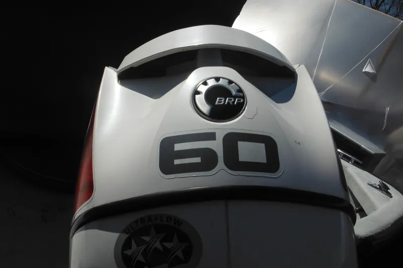 Slide: The Image of Outboard motor on a 1999 Maritime Skiff 1690, featuring BRP 60 horsepower engine. - 14