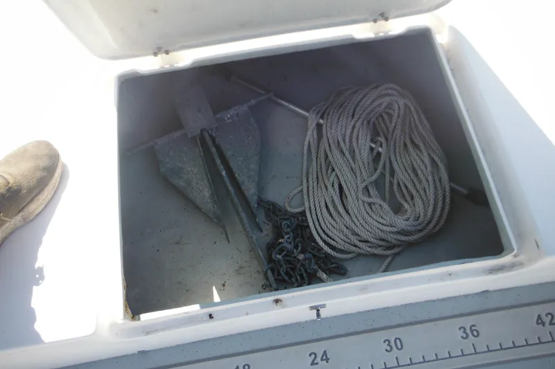 Slide: The Image of Open storage compartment on 1999 Maritime Skiff 1690 with anchor and rope. - 17