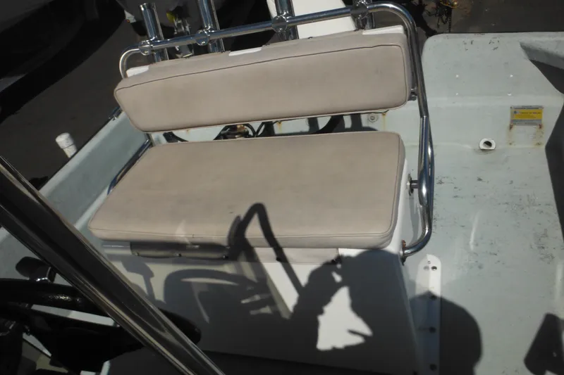 Slide: The Image of 1999 Maritime Skiff 1690 boat interior with cushioned seating and metal frame. - 20