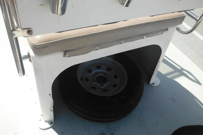 Slide: The Image of Storage compartment with spare tire on a 1999 Maritime Skiff 1690 boat. - 22