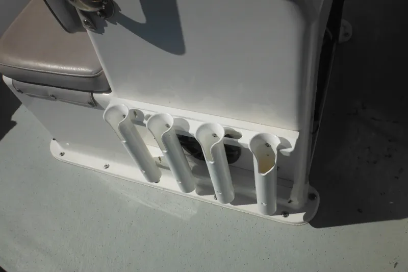 Slide: The Image of Rod holders on a 1999 Maritime Skiff 1690 boat, featuring a cushioned seat. - 23