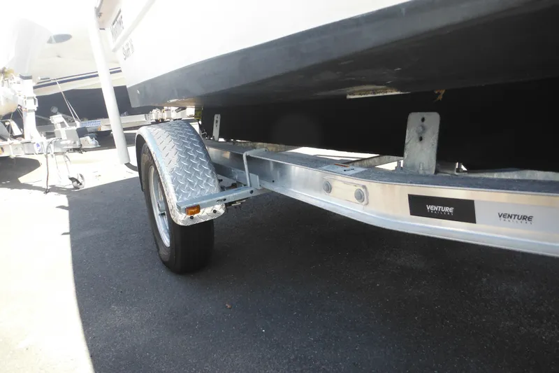 Slide: The Image of Trailer for 1999 Maritime Skiff 1690 boat, featuring Venture branding. - 25