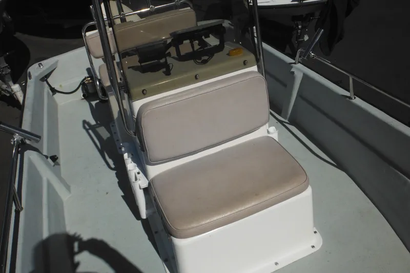 Slide: The Image of 1999 Maritime Skiff 1690 interior with cushioned seating and steering console. - 29