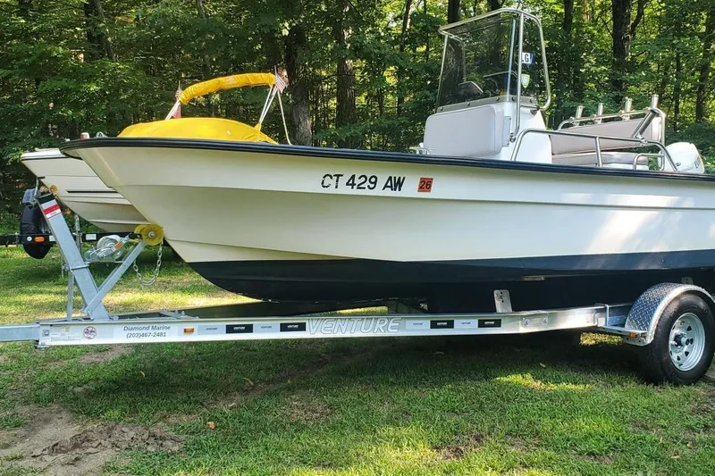 Slide: The Image of 1999 Maritime Skiff 1690 on trailer in wooded area. - 3