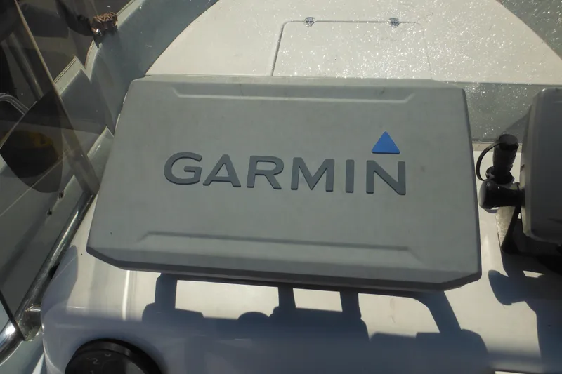 Slide: The Image of Garmin device on 1999 Maritime Skiff 1690 boat dashboard in sunlight. - 37
