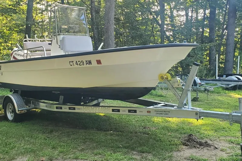 Slide: The Image of 1999 Maritime Skiff 1690 boat on trailer in wooded area. - 4