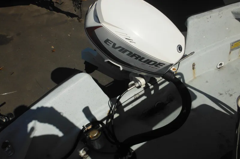 Slide: The Image of 1999 Maritime Skiff 1690 with Evinrude outboard motor, close-up view. - 46