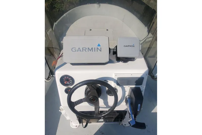 Slide: The Image of 1999 Maritime Skiff 1690 helm with Garmin navigation equipment and steering wheel. - 47