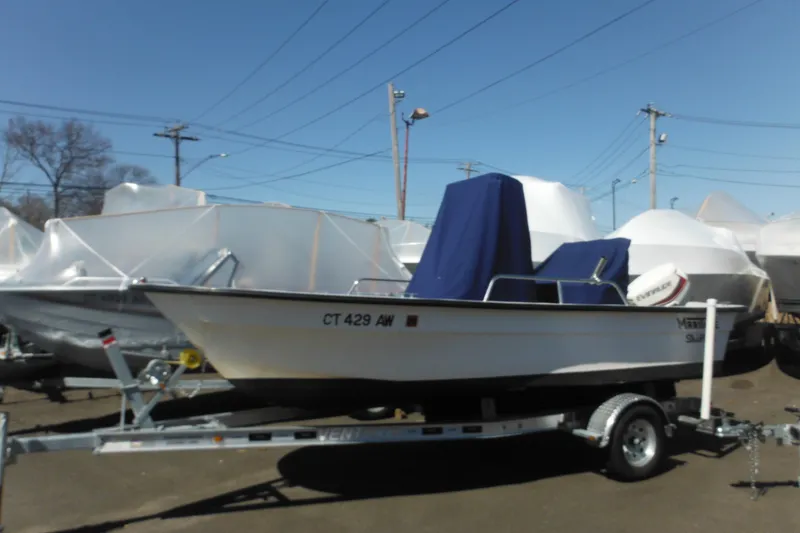 Slide: The Image of 1999 Maritime Skiff 1690 boat on trailer, covered and parked outdoors. - 9