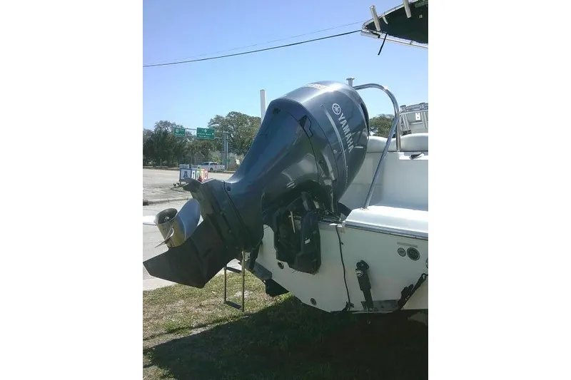 Slide: The Image of 2015 Sea Hunt Ultra 225 boat with Yamaha outboard motor, parked on grass. - 10