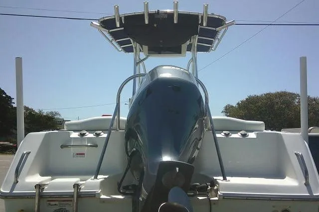 Slide: The Image of 2015 Sea Hunt Ultra 225 boat rear view with outboard motor and T-top. - 12