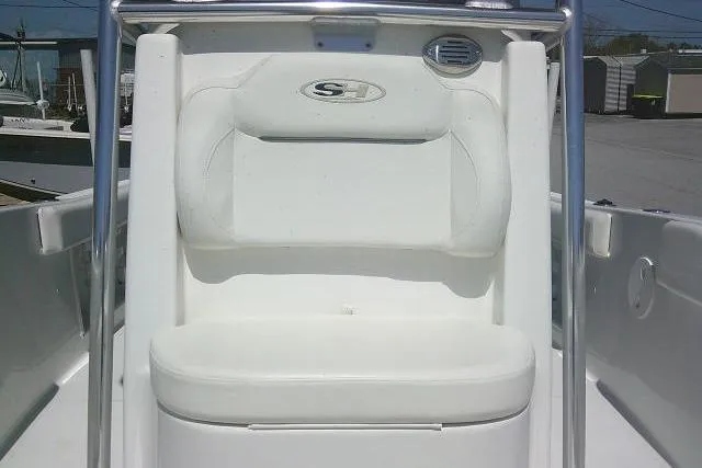Slide: The Image of 2015 Sea Hunt Ultra 225 boat seat with white cushioned backrest and storage compartment. - 16