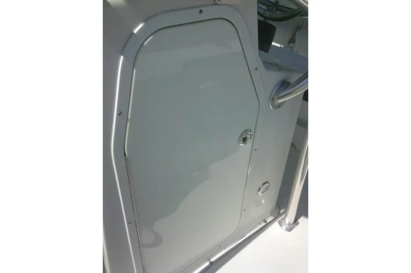 Slide: The Image of 2015 Sea Hunt Ultra 225 boat console door with stainless steel handle. - 19