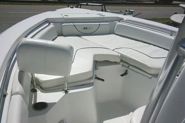 Slide: The Image of 2015 Sea Hunt Ultra 225 boat interior with white cushioned seating. - 20