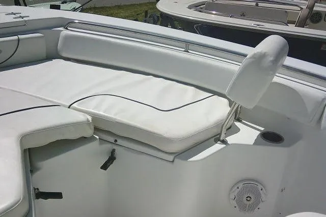 Slide: The Image of 2015 Sea Hunt Ultra 225 boat interior with white cushioned seating and speaker. - 21