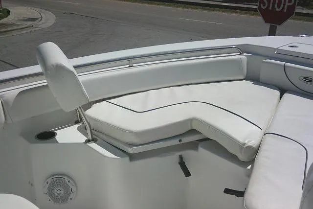 Slide: The Image of 2015 Sea Hunt Ultra 225 boat interior with white cushioned seating. - 22