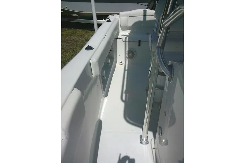 Slide: The Image of 2015 Sea Hunt Ultra 225 boat interior with stainless steel railings and seating area. - 23