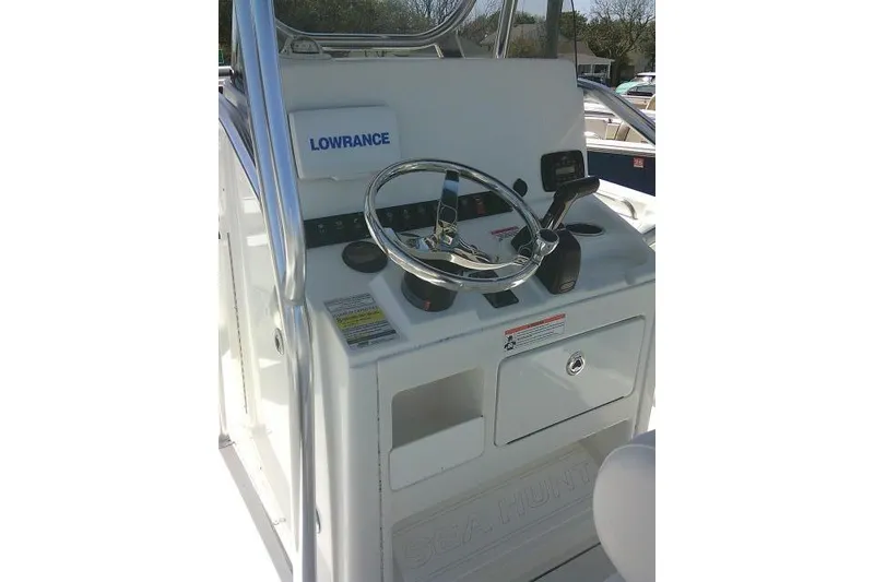 Slide: The Image of 2015 Sea Hunt Ultra 225 boat console with steering wheel and Lowrance equipment. - 25