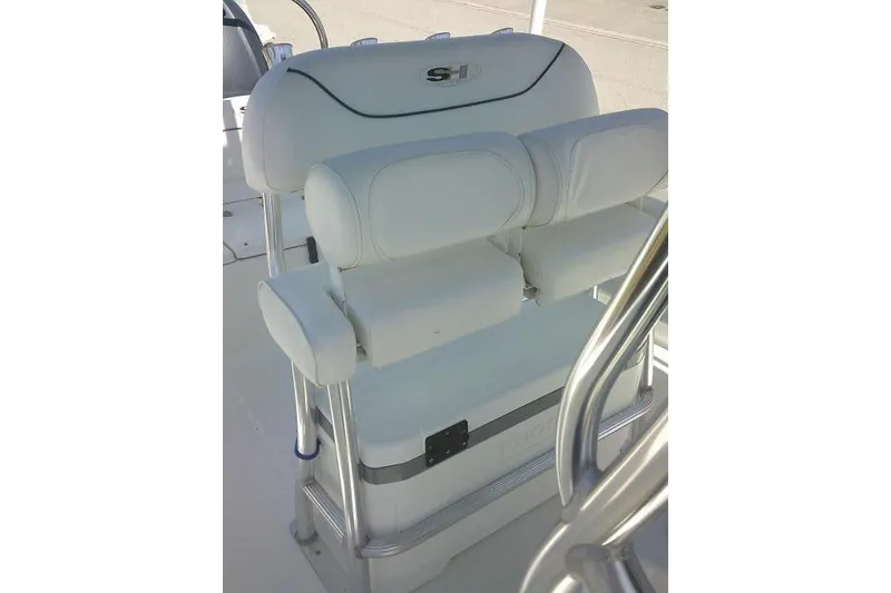 Slide: The Image of 2015 Sea Hunt Ultra 225 boat seat with white upholstery and armrests. - 26