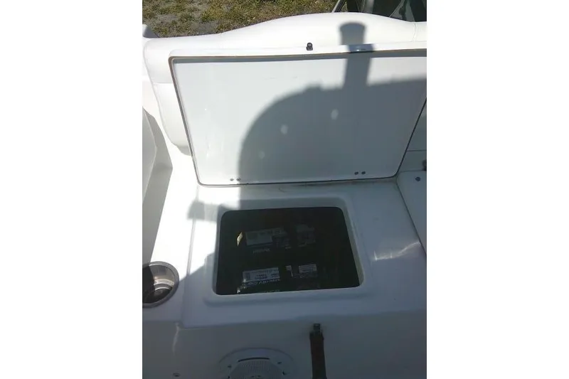 Slide: The Image of Open storage compartment on a 2015 Sea Hunt Ultra 225 boat. - 29