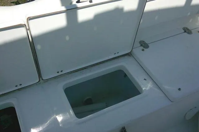 Slide: The Image of Open storage compartment on a 2015 Sea Hunt Ultra 225 boat deck. - 30