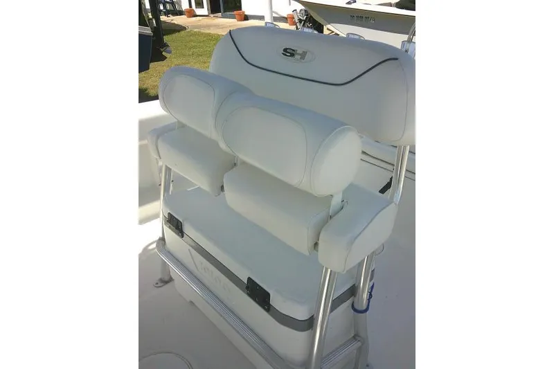 Slide: The Image of 2015 Sea Hunt Ultra 225 boat seat with white cushioned backrest and armrests. - 36
