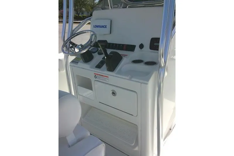 Slide: The Image of 2015 Sea Hunt Ultra 225 boat console with steering wheel and controls. - 39