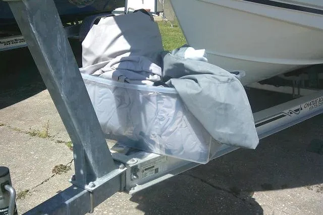 Slide: The Image of 2015 Sea Hunt Ultra 225 boat cover stored in a clear container on a trailer. - 4