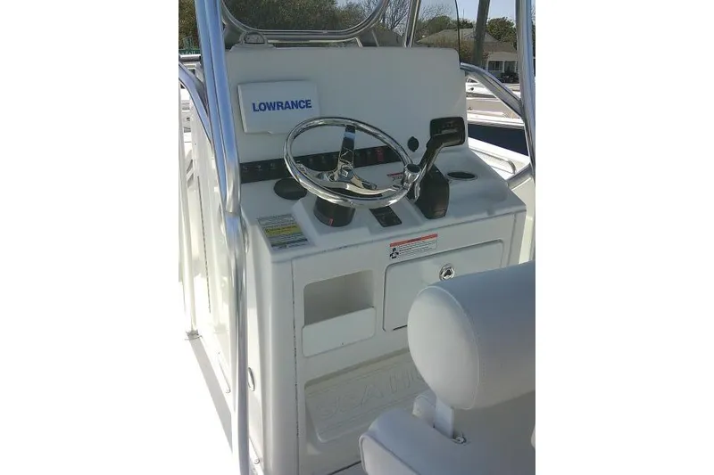 Slide: The Image of 2015 Sea Hunt Ultra 225 boat console with steering wheel and Lowrance equipment. - 45