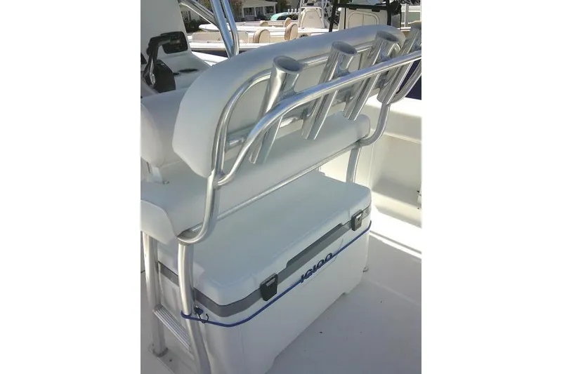 Slide: The Image of 2015 Sea Hunt Ultra 225 boat interior with rod holders and cooler. - 46