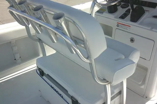 Slide: The Image of 2015 Sea Hunt Ultra 225 boat interior with rod holders and cooler storage. - 50